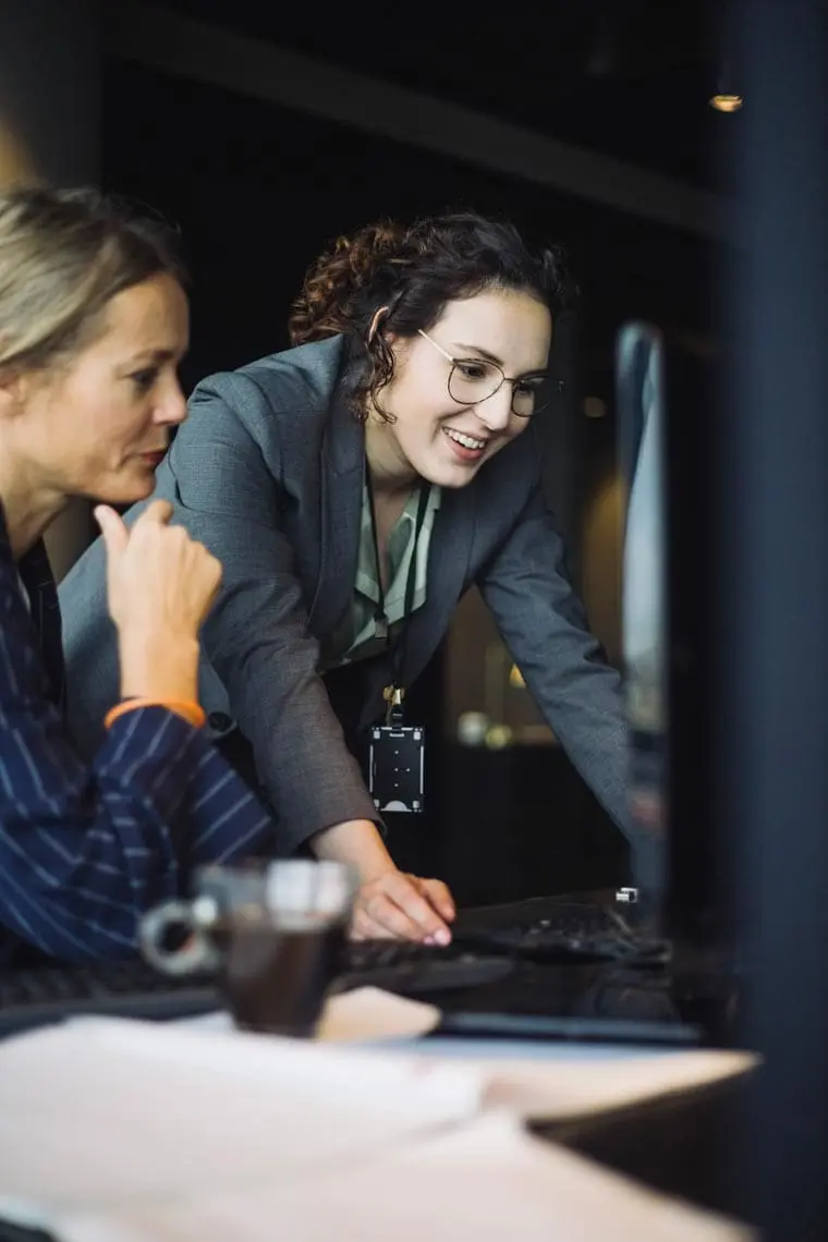 Smiling female IT professionals working on computer in office