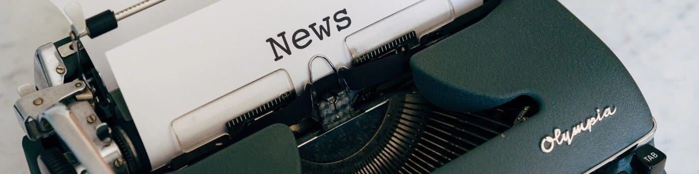 Typewriter with a sheet of paper reading "News."